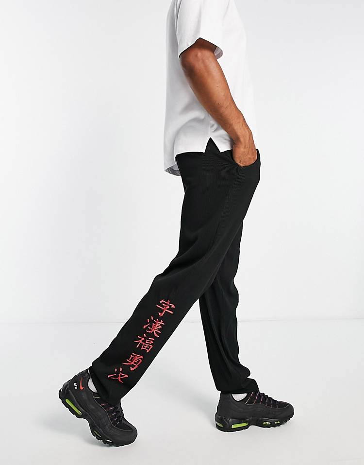 Liquor N Poker straight leg plisse pants in black with japanese text print